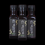 Coffret de 3 bouteilles d'huile d'olive vierge extra bio Racilia 100 ml sur fond noir